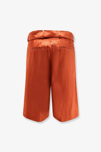 Back view of dries van noten women’s cotton blend bermuda shorts in crisp orange satin with matching belt and tailored pockets