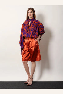 Dries Van Noten women’s cotton blend bermuda shorts in vibrant orange satin with high waist and subtle pleats
