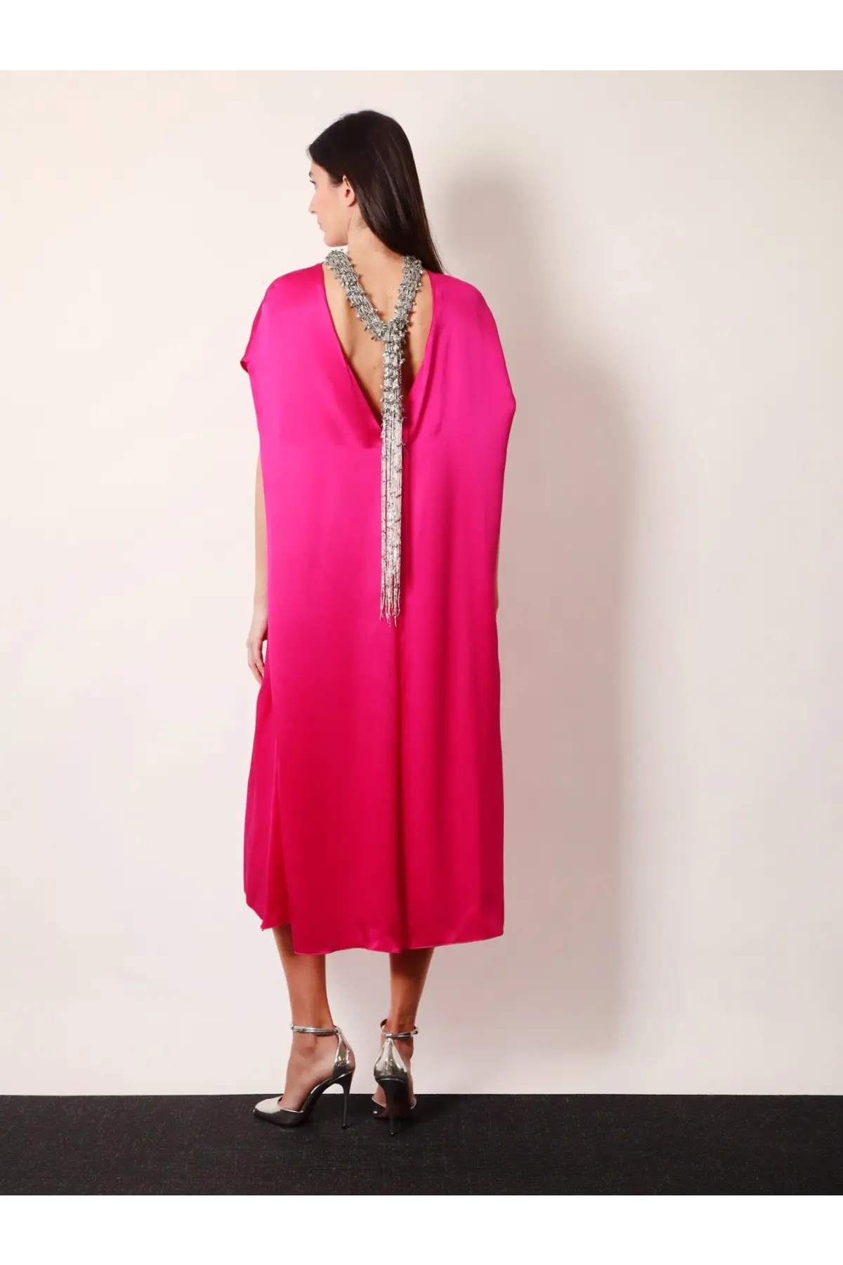 Back view of a vibrant fuchsia satin Dries Van Noten silk dress with deep back neckline and silver beaded fringe embellishment
