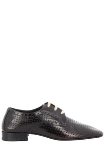 Black patent leather lace-up oxford shoe with perforated detailing and cream-colored laces for women