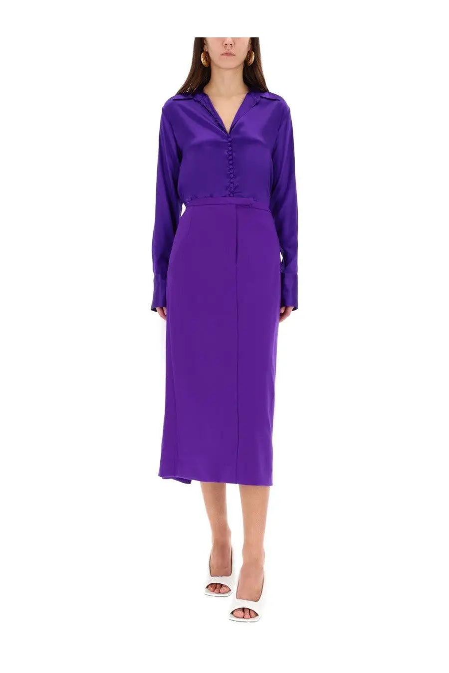 A sleek vibrant purple satin button-down blouse paired with a matching high-waisted midi skirt by Dries Van Noten