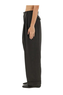 Dries Van Noten women’s black high-waisted wide-leg trousers with tailored pleated front and rolled cuffs