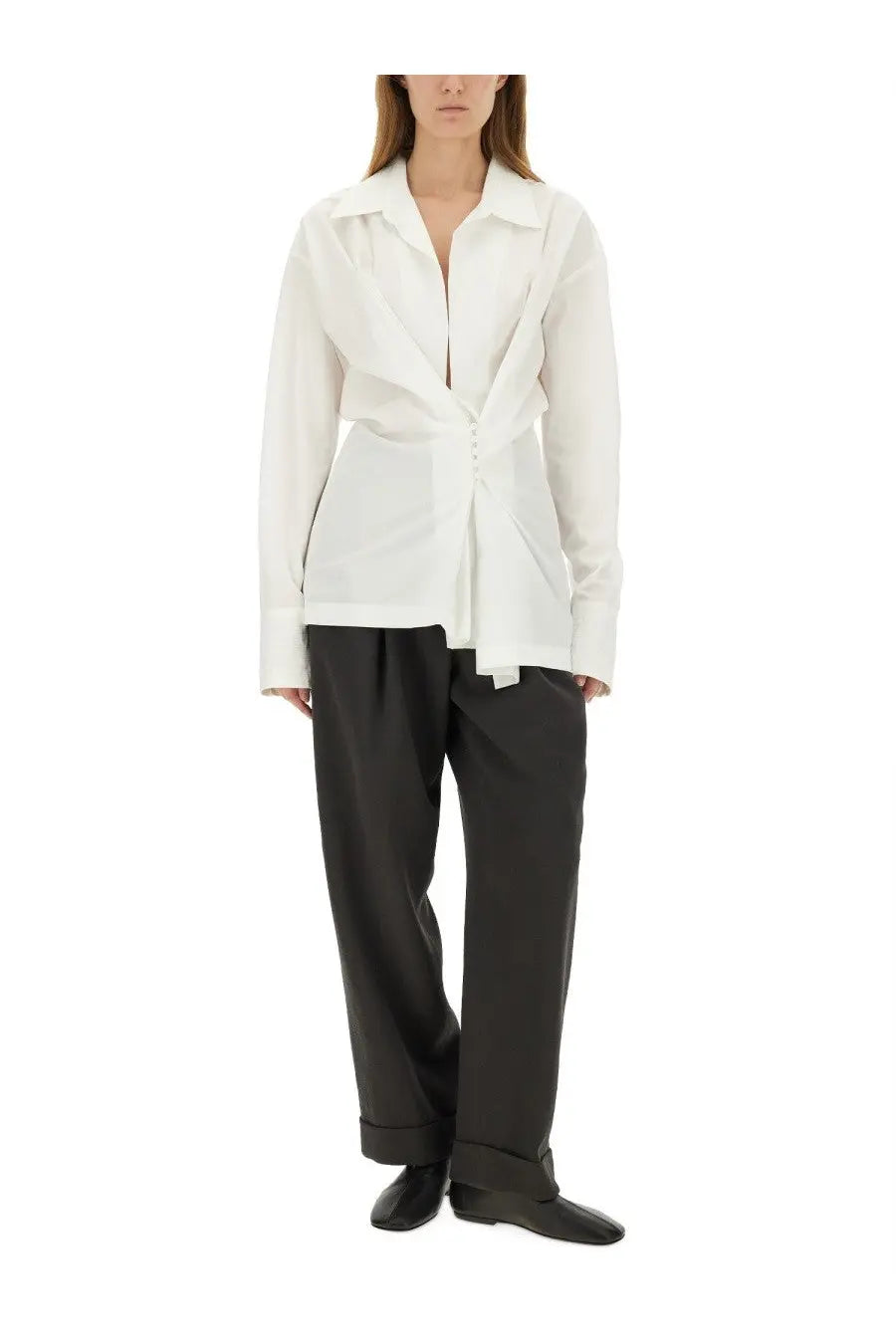 A white long-sleeved shirt with structured collar and asymmetrical front paired with Dries Van Noten grey pants