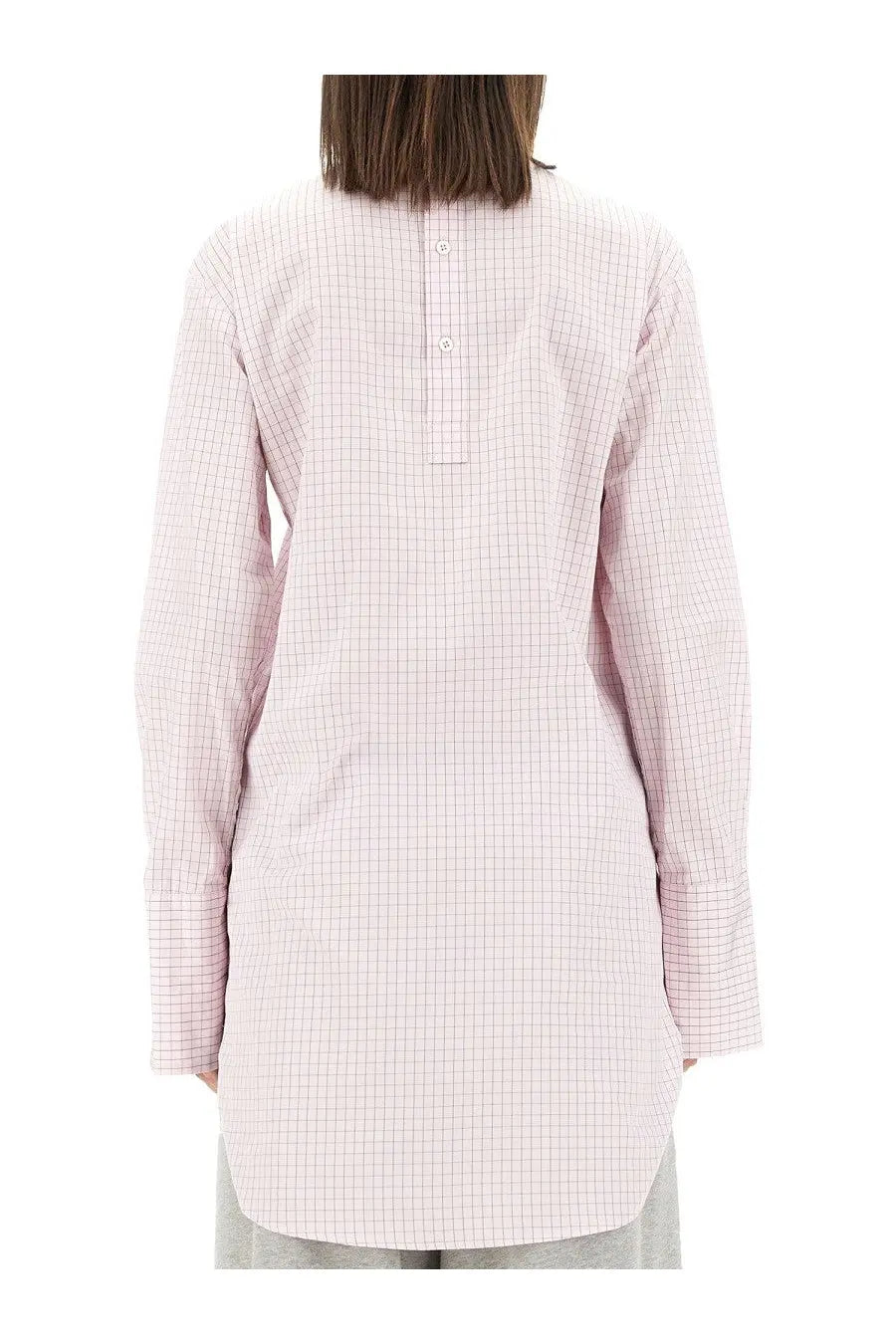A soft pink and white checkered long-sleeved tunic shirt with a buttoned back closure by dries van noten