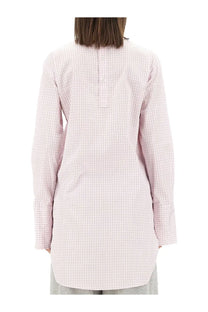 A soft pink and white checkered long-sleeved tunic shirt with a buttoned back closure by dries van noten