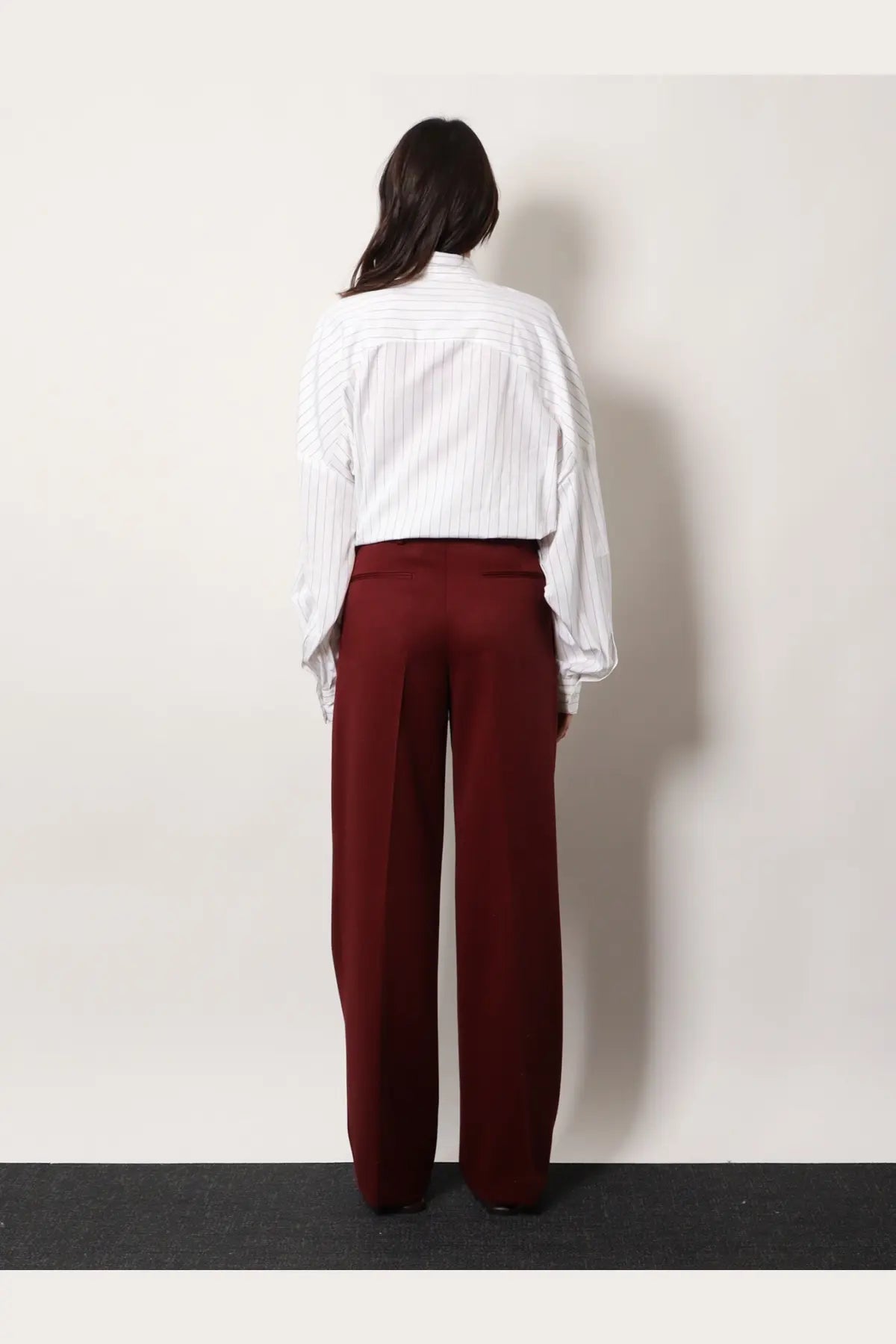 A pair of wide-leg burgundy wool trousers with a smooth tailored fit by dries van noten women