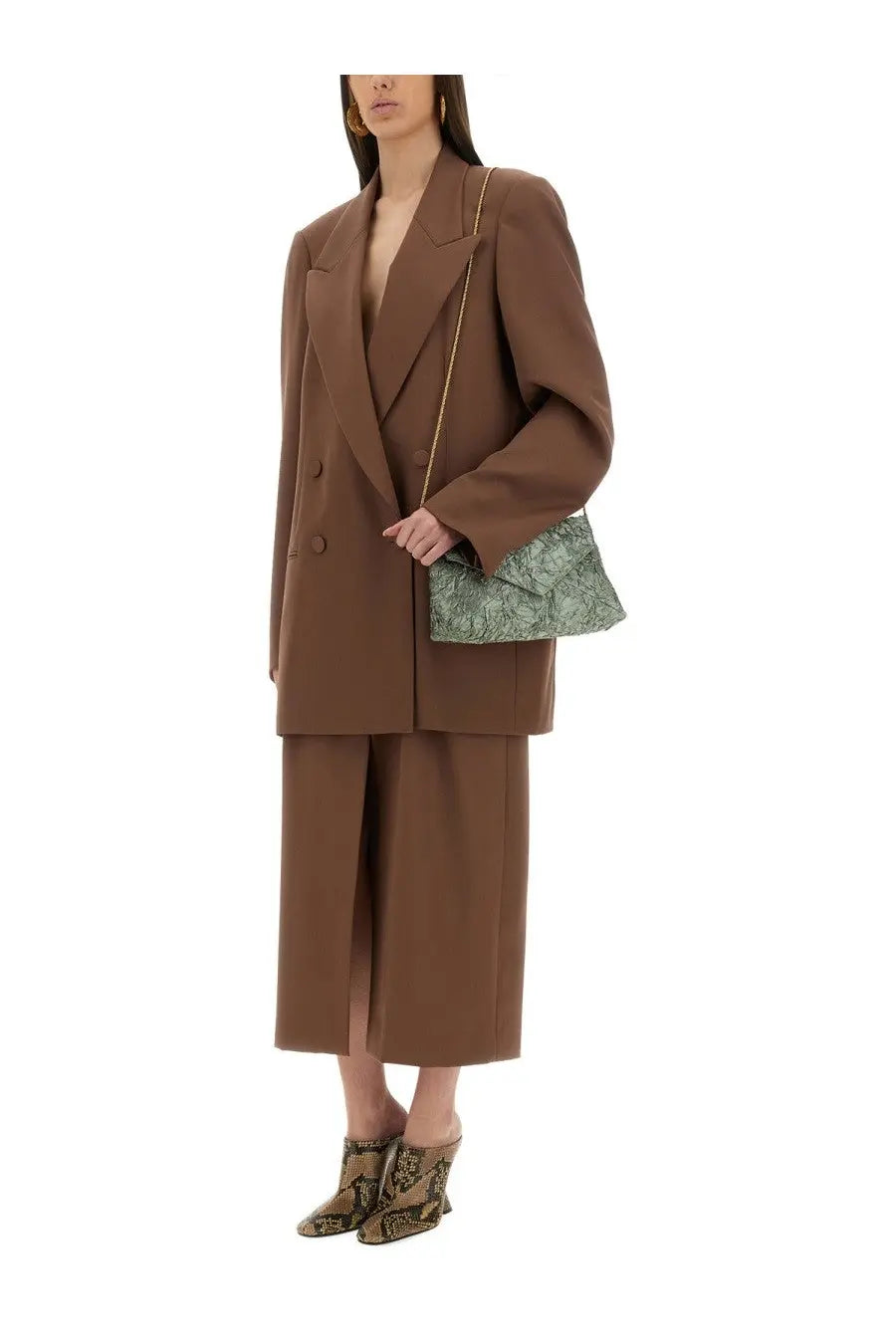 A green patterned handbag with a gold chain strap paired with a dries van noten women’s brown wool skirt