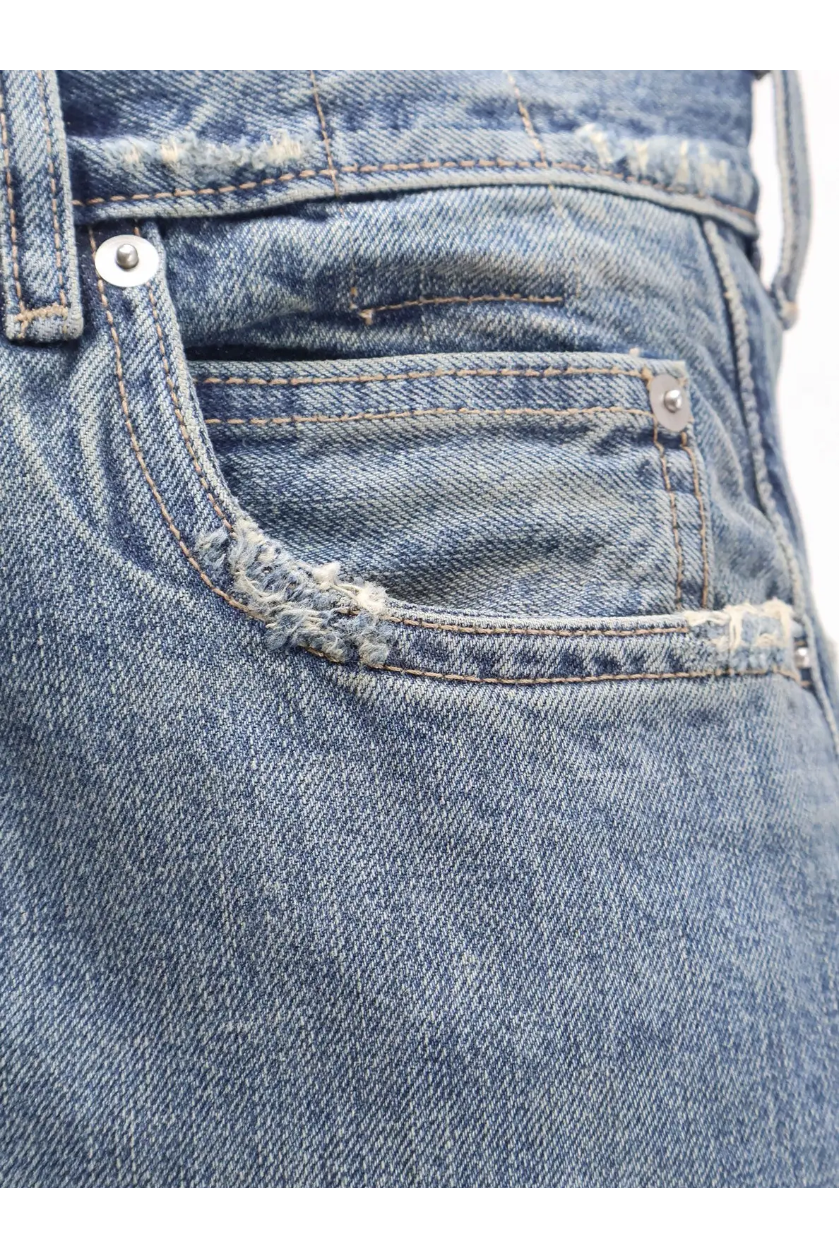 Distressed blue denim jeans pocket with frayed edges and silver rivets on drkshdw mens blue jeans back side