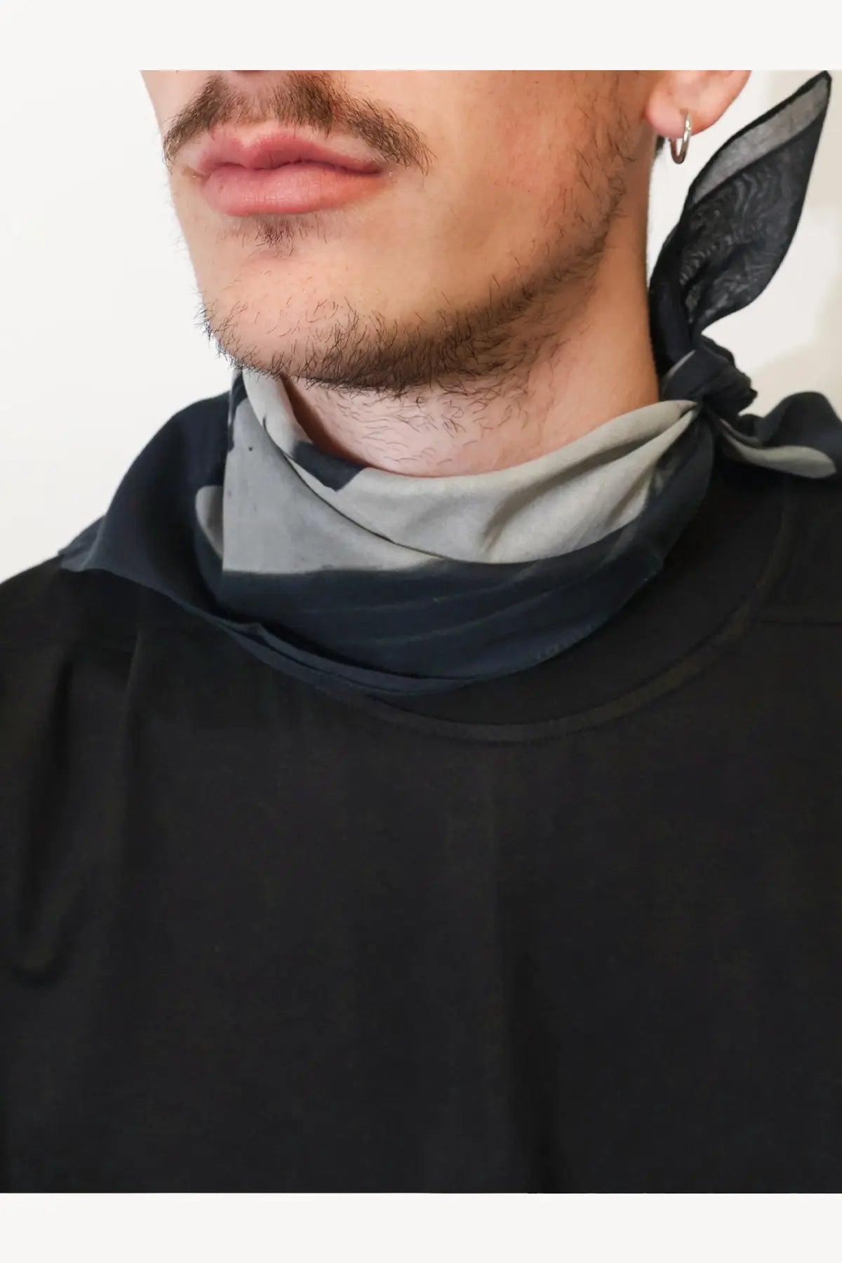 Drkshdw men’s cotton foulard black silk scarf with black and gray pattern tied around the neck