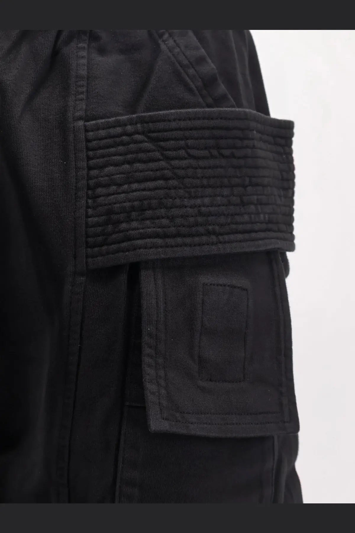 Drkshdw men’s black cotton cargo pants with textured quilted flap pocket detail on the back side