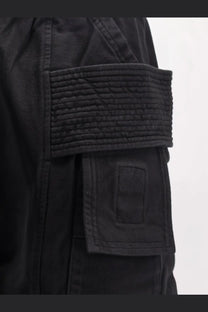 Drkshdw men’s black cotton cargo pants with textured quilted flap pocket detail on the back side