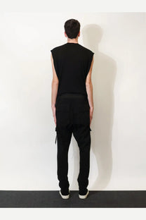 Black sleeveless top with relaxed fit and subtle side slits paired with drkshdw men’s black cotton trousers