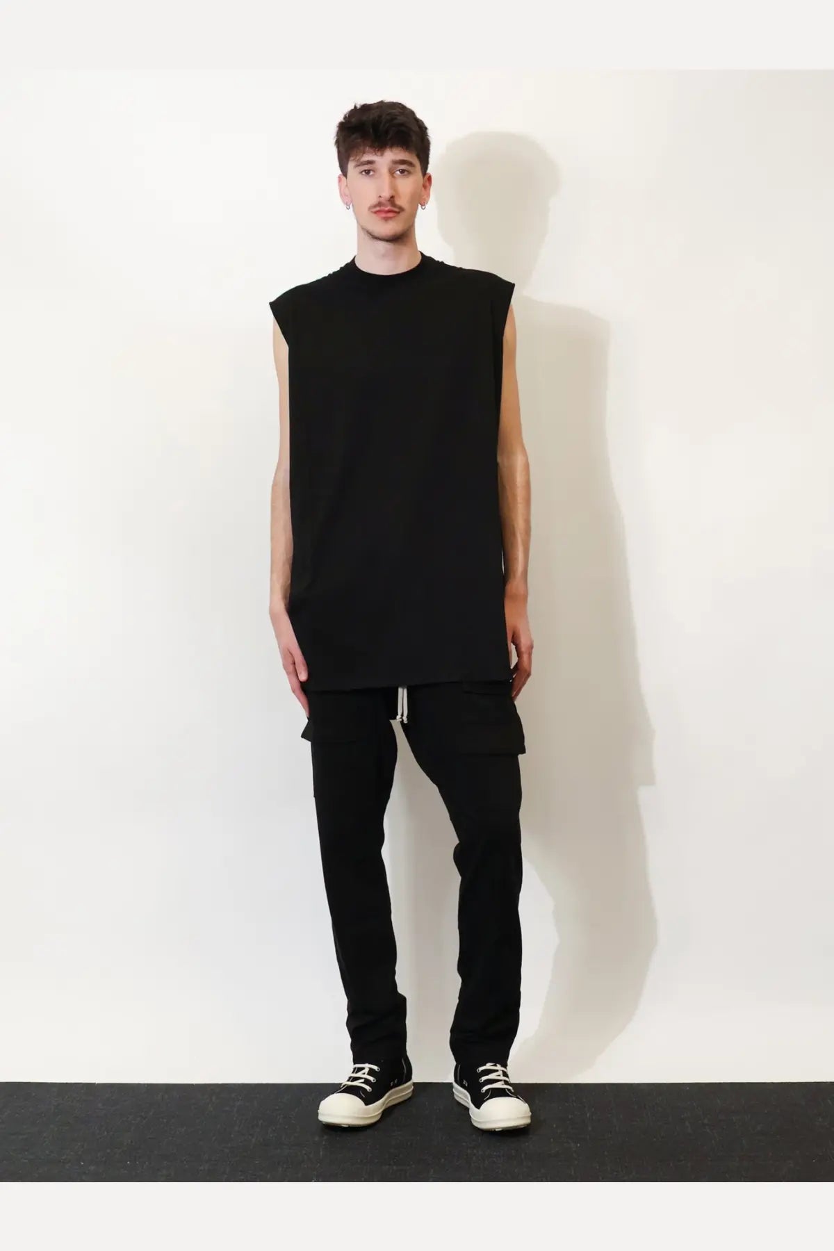 Black sleeveless t-shirt with relaxed oversized fit and ribbed neckline paired with drkshdw men’s cotton trousers black