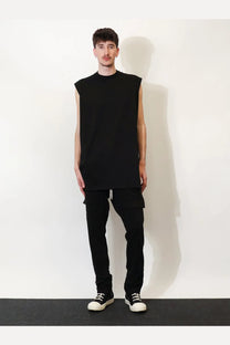 Black sleeveless t-shirt with relaxed oversized fit and ribbed neckline paired with drkshdw men’s cotton trousers black