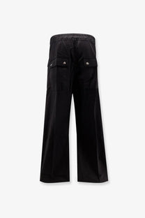 Back view of drkshdw men’s black cotton wide-leg cargo pants with elastic waistband and silver button pockets