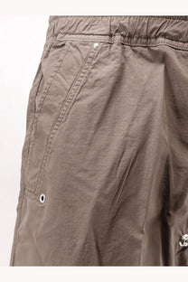 Beige cargo shorts with drawstring waistband and multiple pockets featuring subtle stitching details from drkshdw men’s cotton trousers gray collection