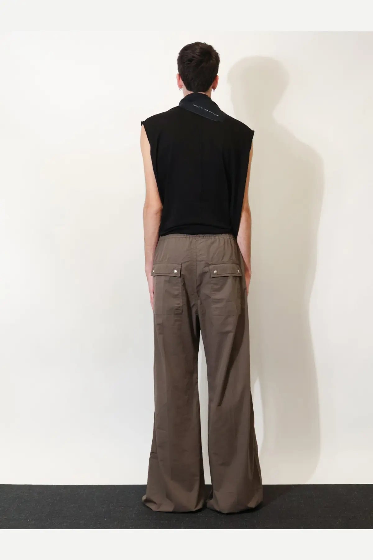 Back view of drkshdw men’s grey cotton trousers with brown wide-leg cargo pants style and two flap pockets