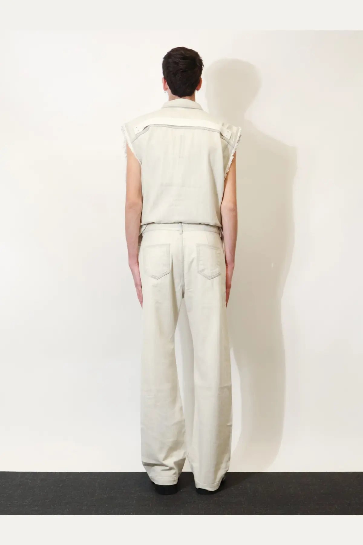 A cream-colored sleeveless denim vest with structured collar and subtle stitching from drkshdw men’s denim jeans white collection