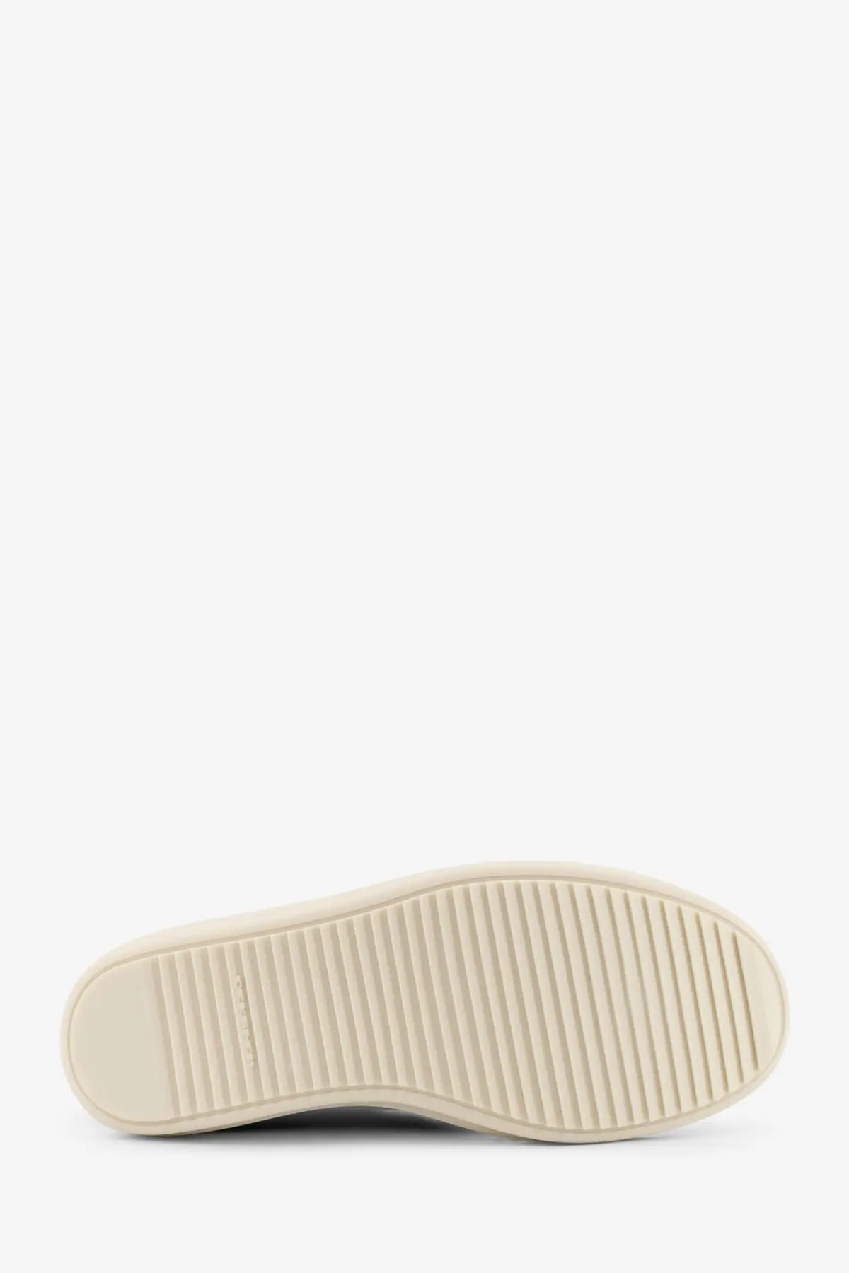 Cream-colored rubber sole with parallel grooves for traction on drkshdw men’s black denim sneakers back side