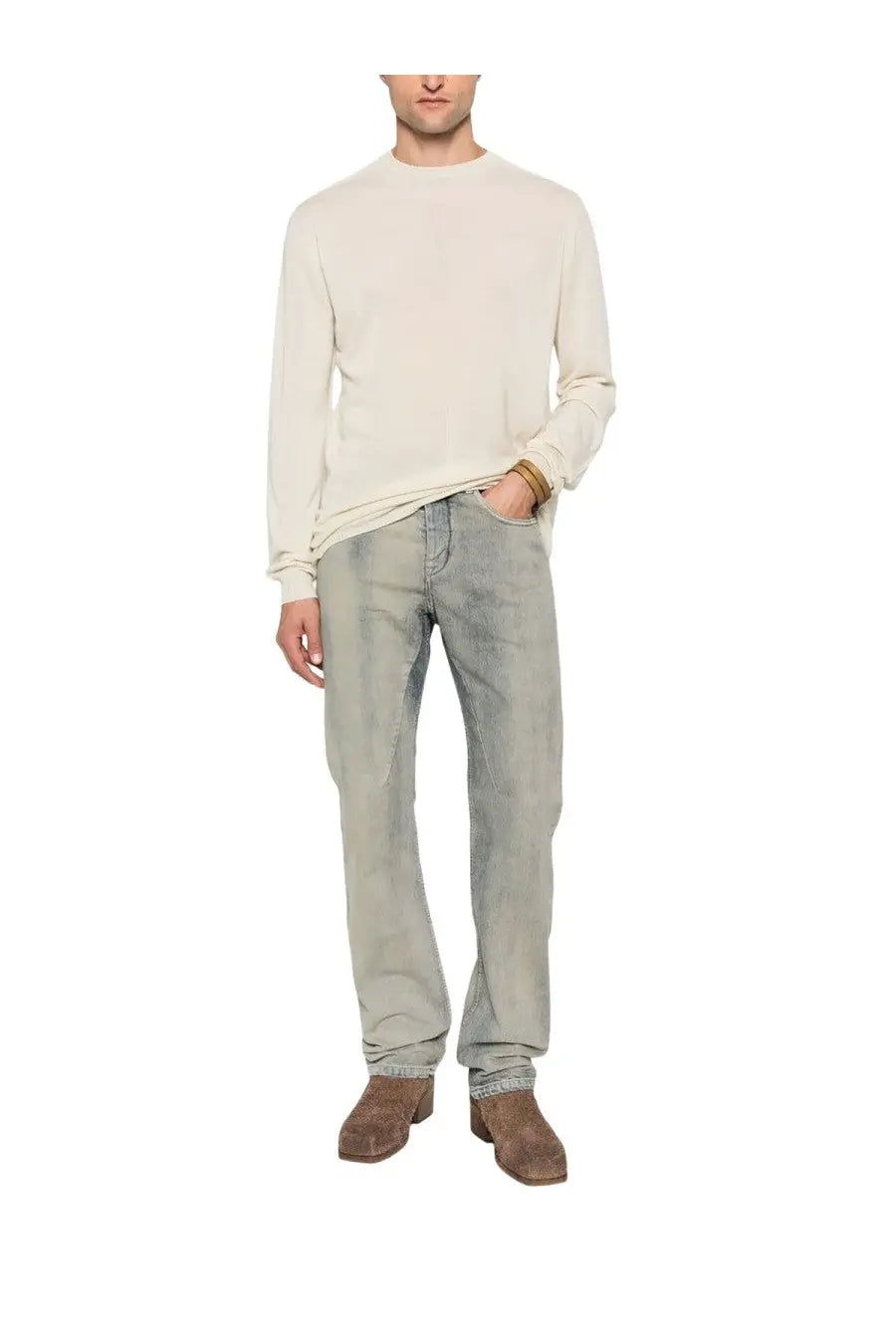 A man wearing drkshdw men’s fog cut jeans blue with light-wash denim and a cream-colored long-sleeved sweater