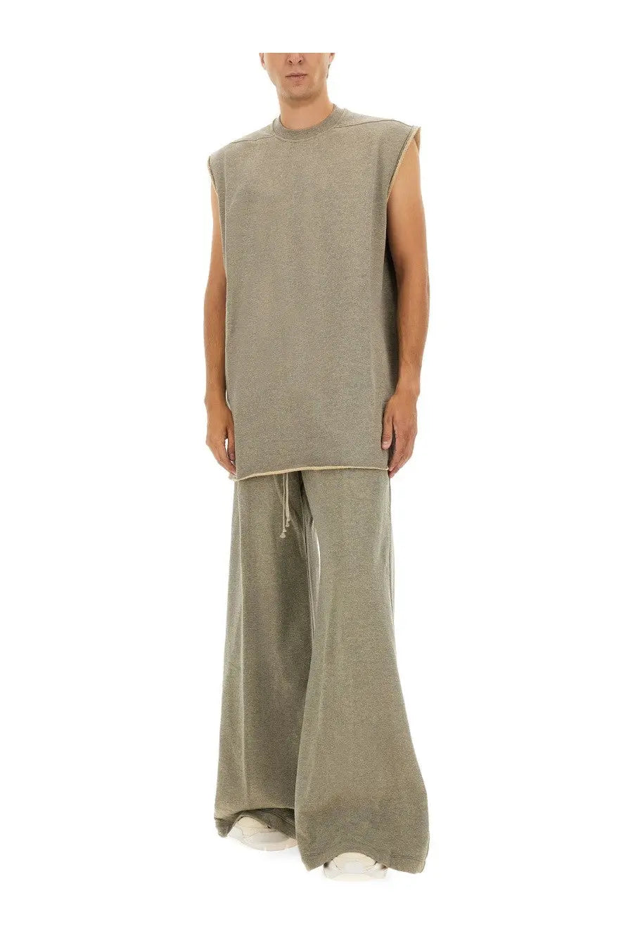 Drkshdw men’s grey pants paired with a loose-fitting olive green sleeveless top with subtle ribbed texture