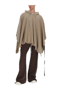 Beige hooded poncho with frayed hem and drawstring detailing paired with drkshdw men’s pants pusher brown