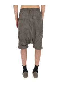 Gray glossy nylon drkshdw men’s shorts with elastic waistband and two back pockets shown from the back side