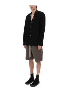 Black long-sleeved button-up shirt with silver buttons and oversized fit styled with drkshdw men’s shorts wide pusher brown