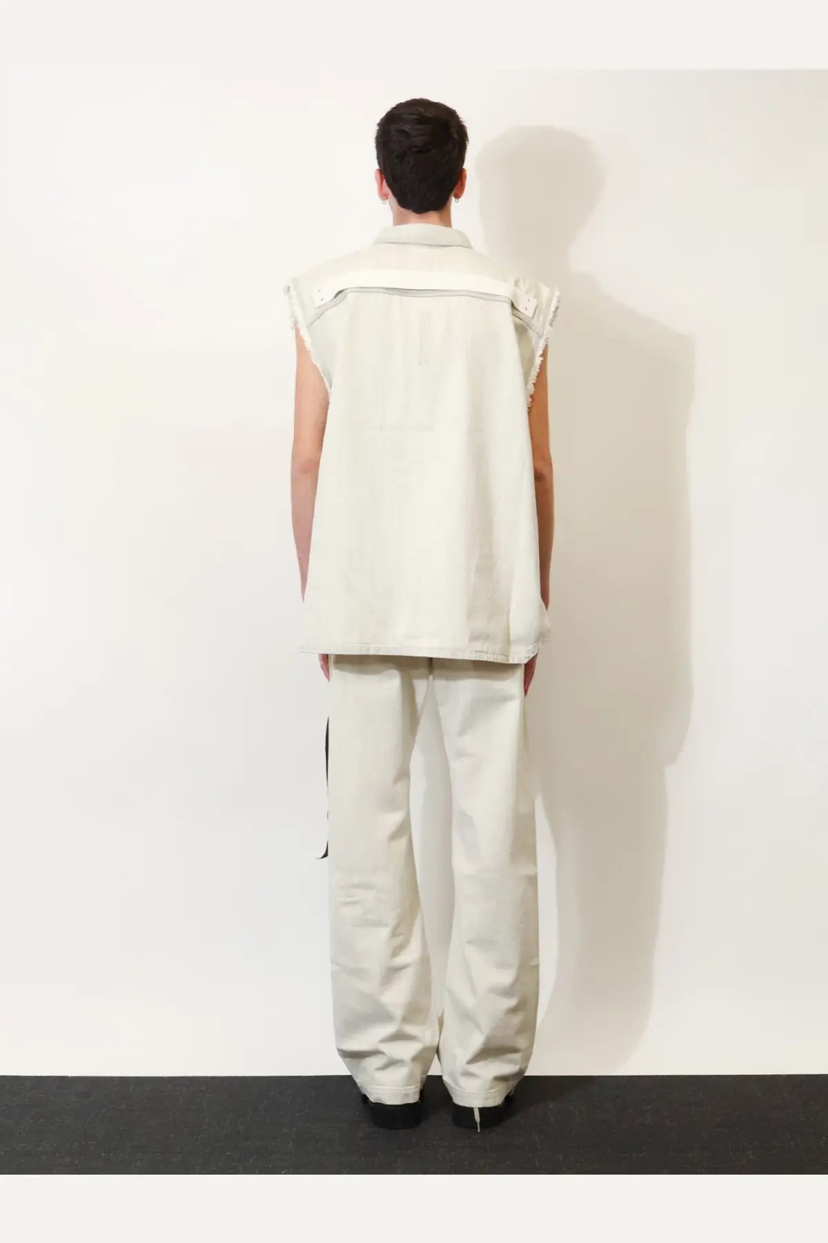Cream-colored sleeveless denim vest with structured collar and frayed edges from DRKSHDW men’s white jacket collection