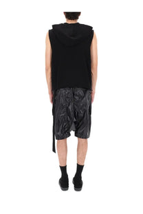 Black hooded sleeveless top with glossy reflective fabric and asymmetrical side slits by DRKSHDW men’s hooded tunic black