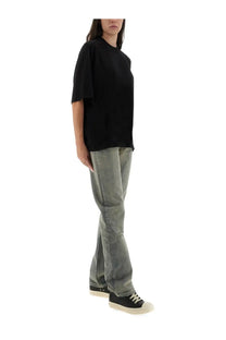 Black oversized short-sleeved t-shirt with relaxed fit paired with drkshdw women’s concordians fog cut grey pants