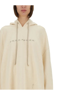 Cream-colored oversized DRKSHDW women’s Peter sweatshirt with subtle hollywood graphic and matching drawstrings