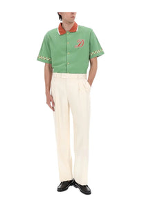 Drôle de Monsieur men’s green short-sleeved polo shirt with orange trim and red embroidered d on chest