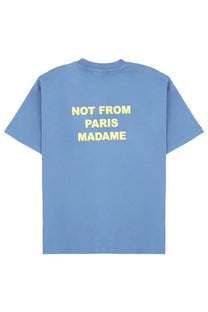 Back view of drôle de monsieur men’s light blue cotton t-shirt with bold yellow not from paris madame text graphic