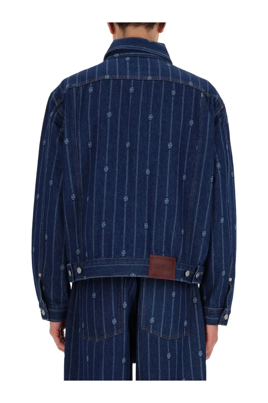 Dark blue denim monogramme jacket with vertical white pinstripes and subtle embroidered skull motifs by drôle de monsieur