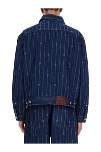 Dark blue denim monogramme jacket with vertical white pinstripes and subtle embroidered skull motifs by drôle de monsieur