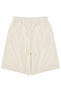 Cream-colored textured drôle de monsieur men’s monogramme shorts with elastic waistband in white fabric