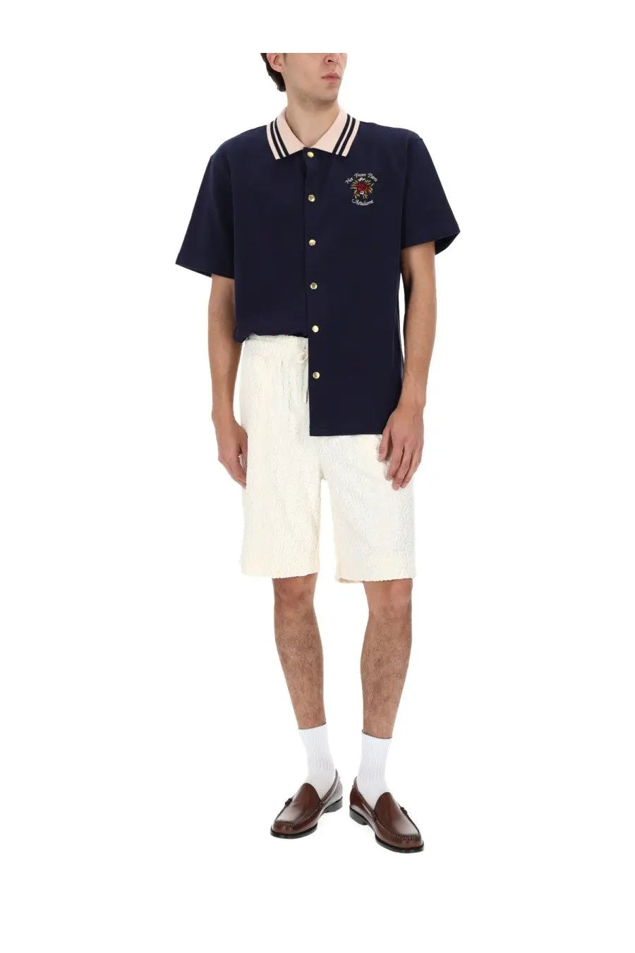 Navy blue short-sleeved polo shirt with white and cream striped collar gold buttons and an embroidered crest on chest