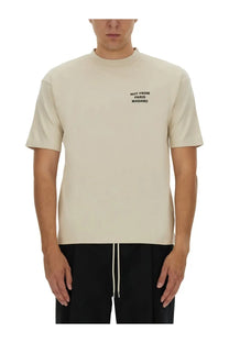 Drôle de monsieur men’s beige crew-neck t-shirt with black embroidered slogan not from paris madame on the left chest