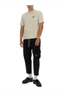 Beige short-sleeved cotton t-shirt with a small black text logo on the chest by Drôle de Monsieur