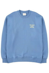 Drôle de Monsieur men’s soft light blue crewneck sweatshirt with subtle gold embroidered slogan on left chest