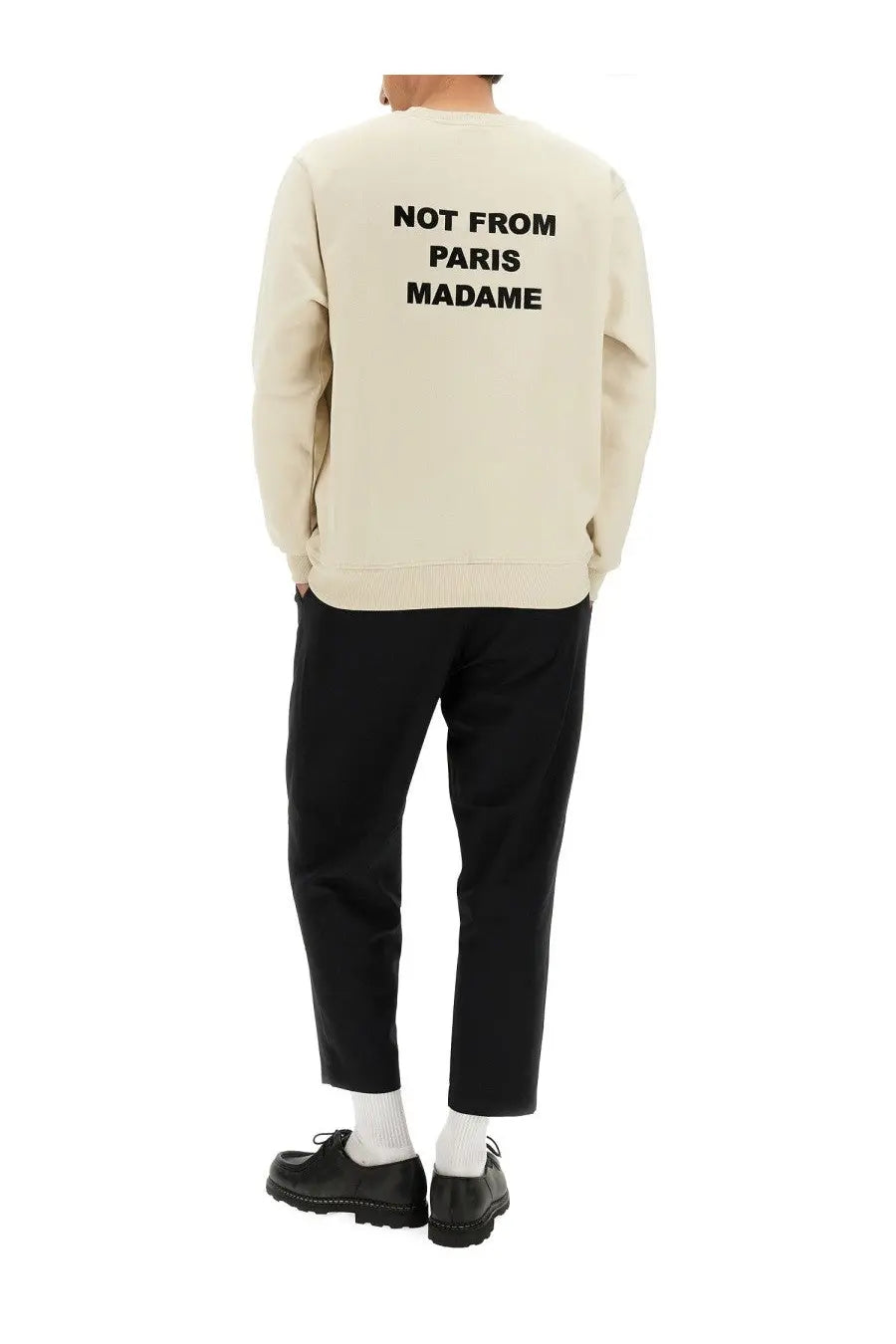 Cream-colored drôle de monsieur men’s sweatshirt with bold black slogan not from paris madame on the back
