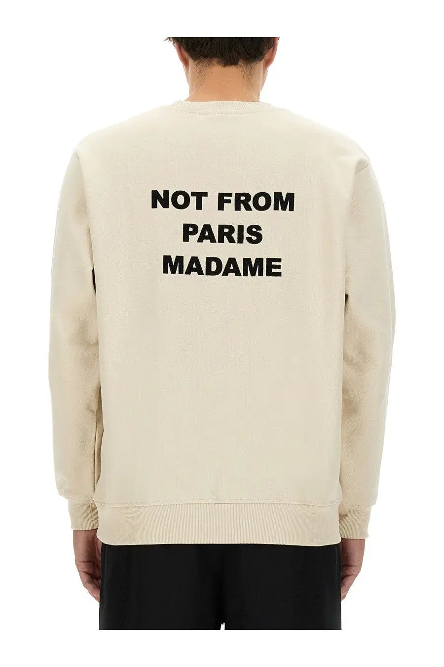 Cream-colored drôle de monsieur men’s sweatshirt with bold black not from paris madame text on the back