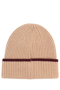 Beige wool knit beanie by drôle de monsieur with ribbed texture and burgundy stripe on folded brim