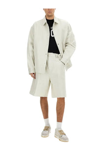 A man wearing a cream-colored oversized button-up jacket from Dsquared2 men’s icon new generation overshirt white