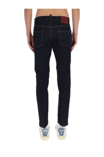 Dsquared2 men’s slim fit dark wash denim jeans with contrasting stitching and brown leather brand patch on waistband back view