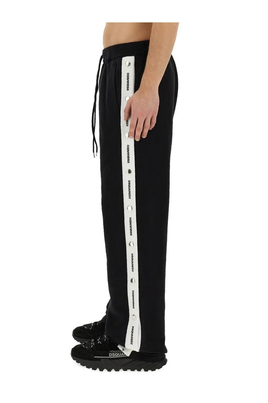 Dsquared2 men’s black jogging pants with bold white vertical stripe featuring repeating logos and silver eyelets along side
