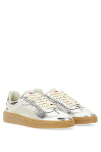 Silver metallic sneakers with a gum rubber sole and cream-colored laces.