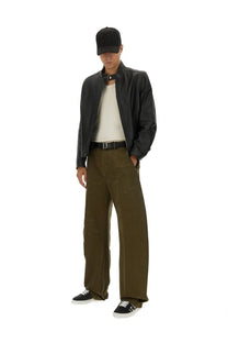 Black leather jacket with high collar and zipper closure paired with dsquared2 men’s ripped big chino pants green