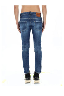 Back side of dsquared2 men’s skater jeans blue in slim fit faded wash denim with brown leather brand patch on waistband
